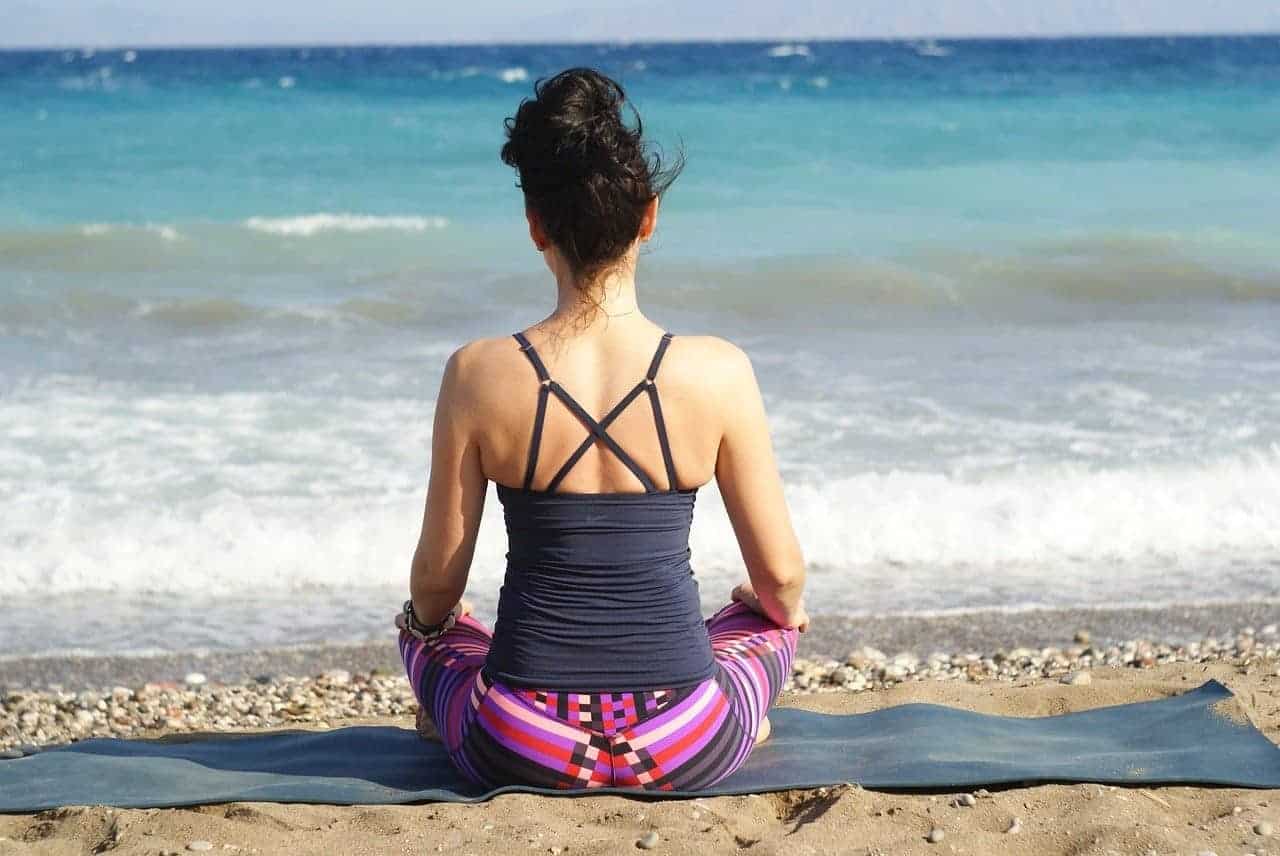 woman meditating ocean