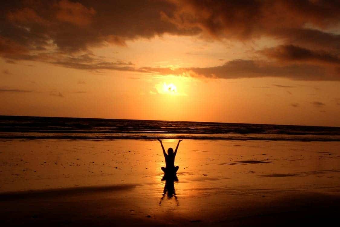 meditating person sunset