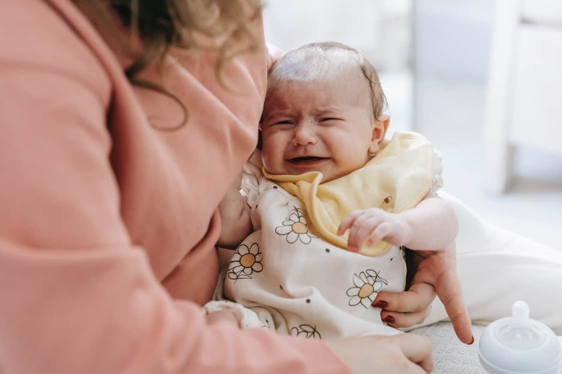 holding crying baby