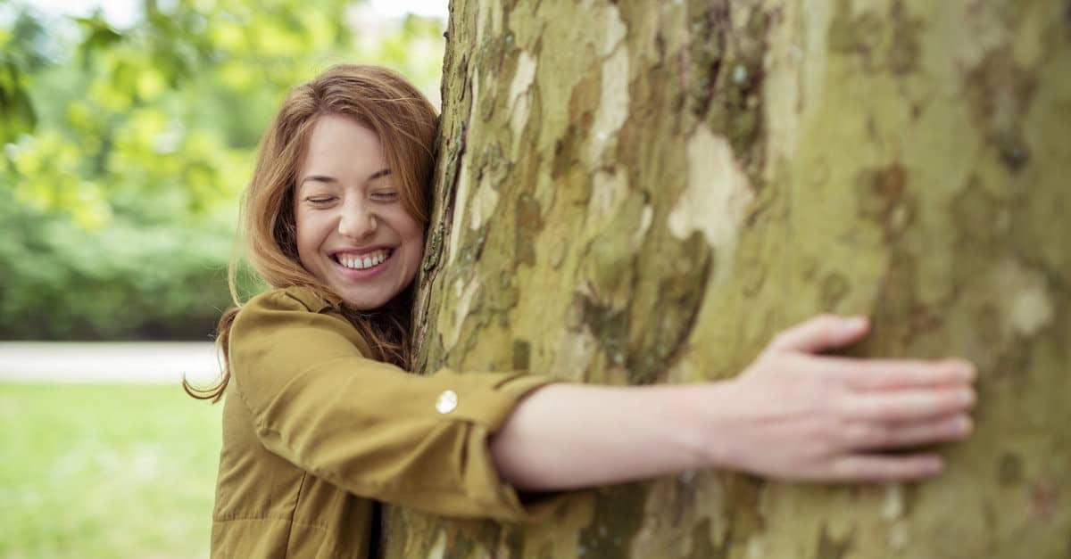 woman hugging tree