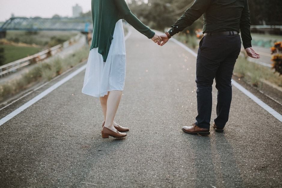 road couple holding hands