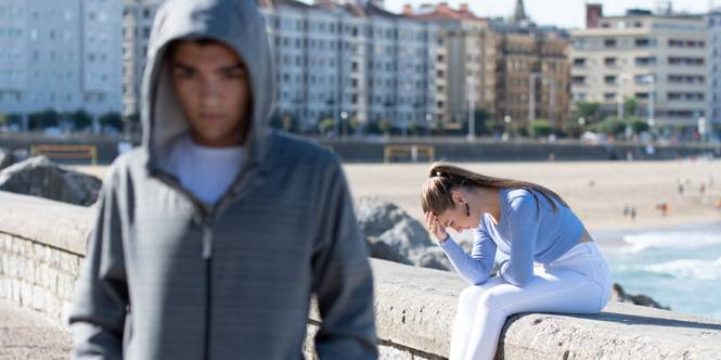 man in a hoodie and a sad woman