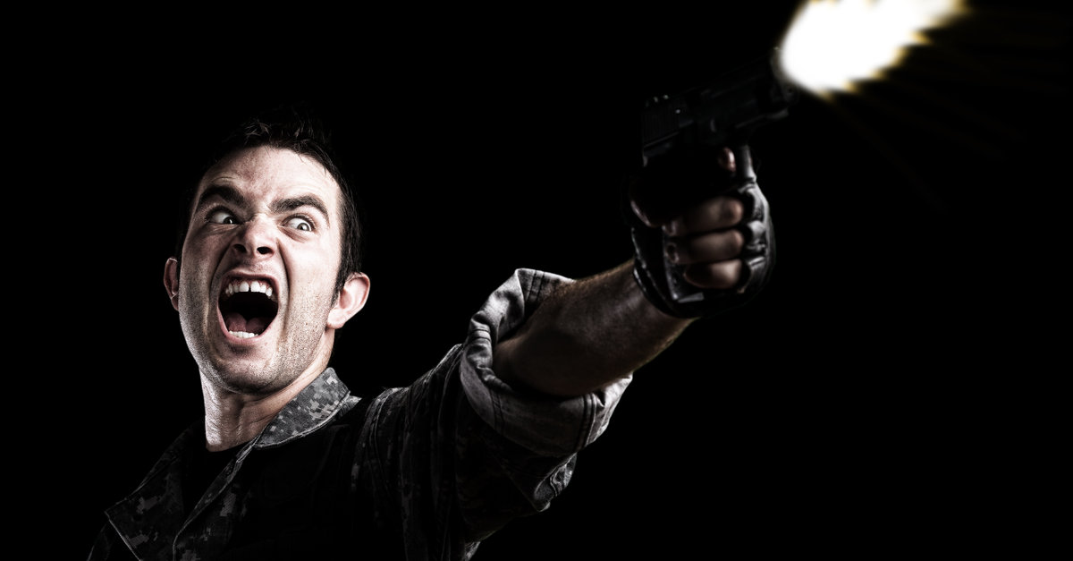 man shooting on a black background