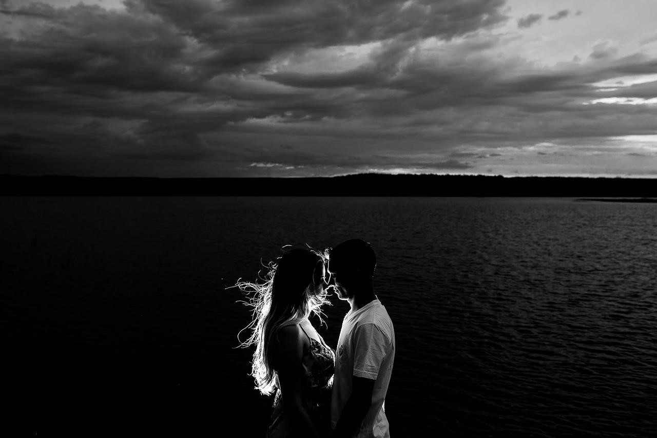 black and white photo of couple on a beach