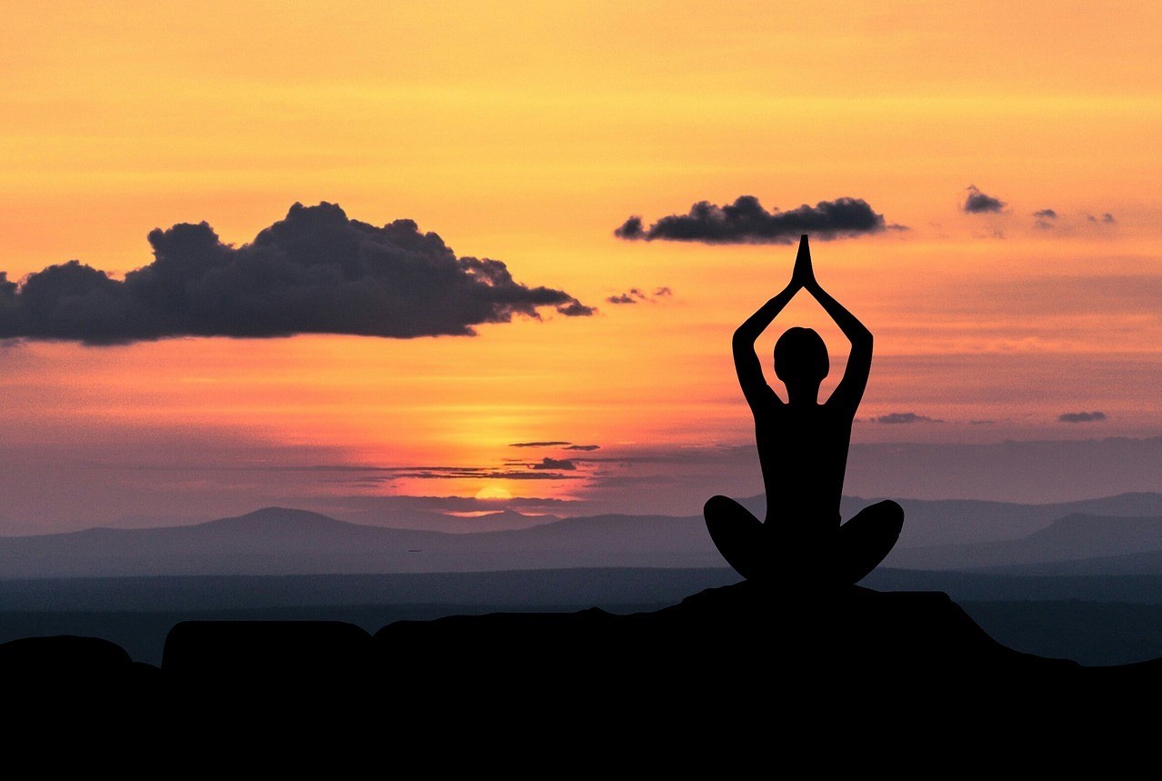 silhouette of a woman doing yoga