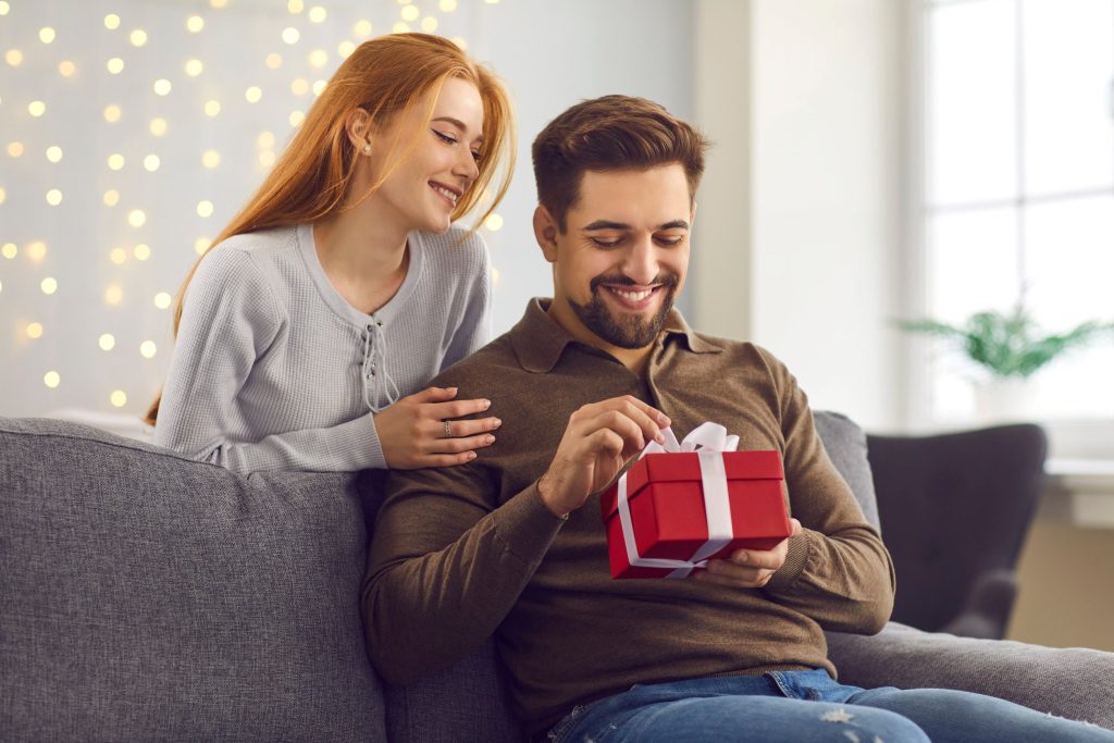 woman giving a gift to her man