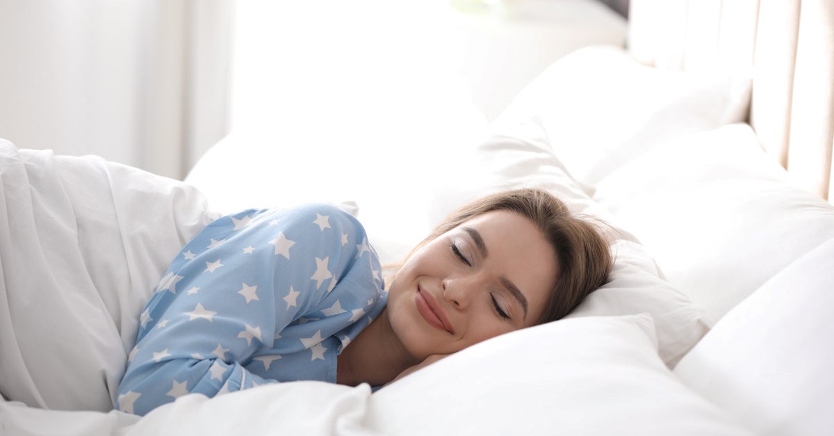 woman smiling while sleeping