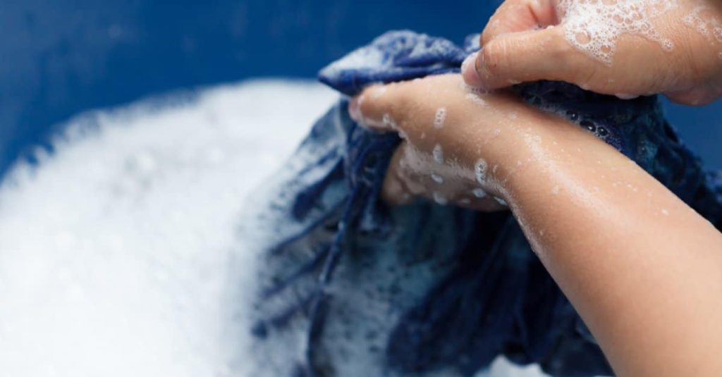 woman washing clothes by hand