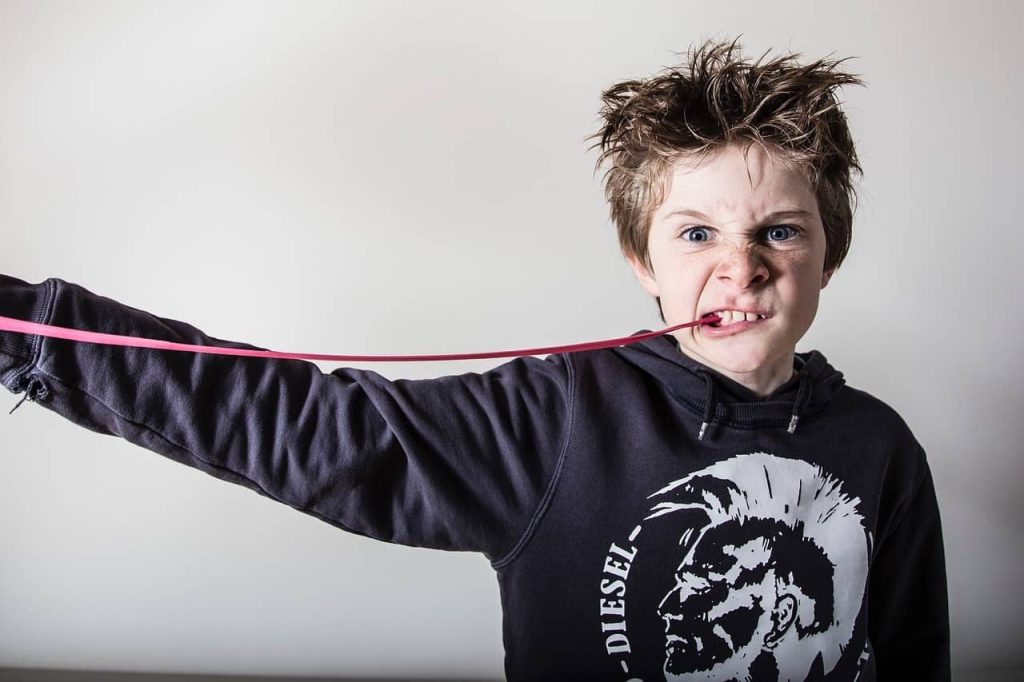 boy stretching gum