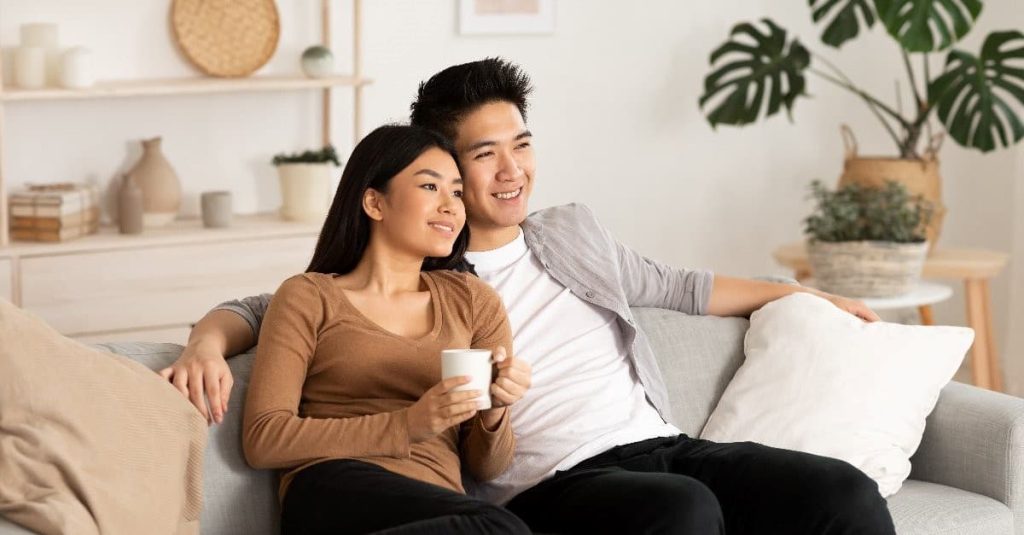 couple watching movie in a couch