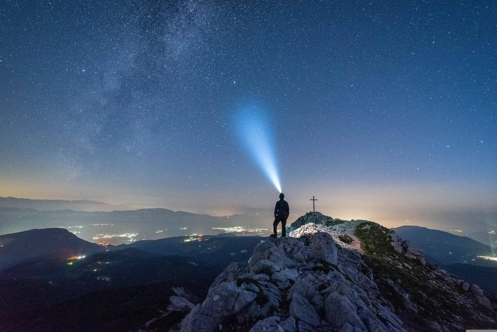 man emitting blue light to the sky