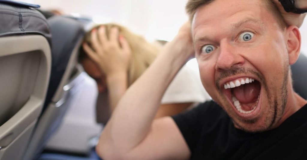 man screaming on a plane