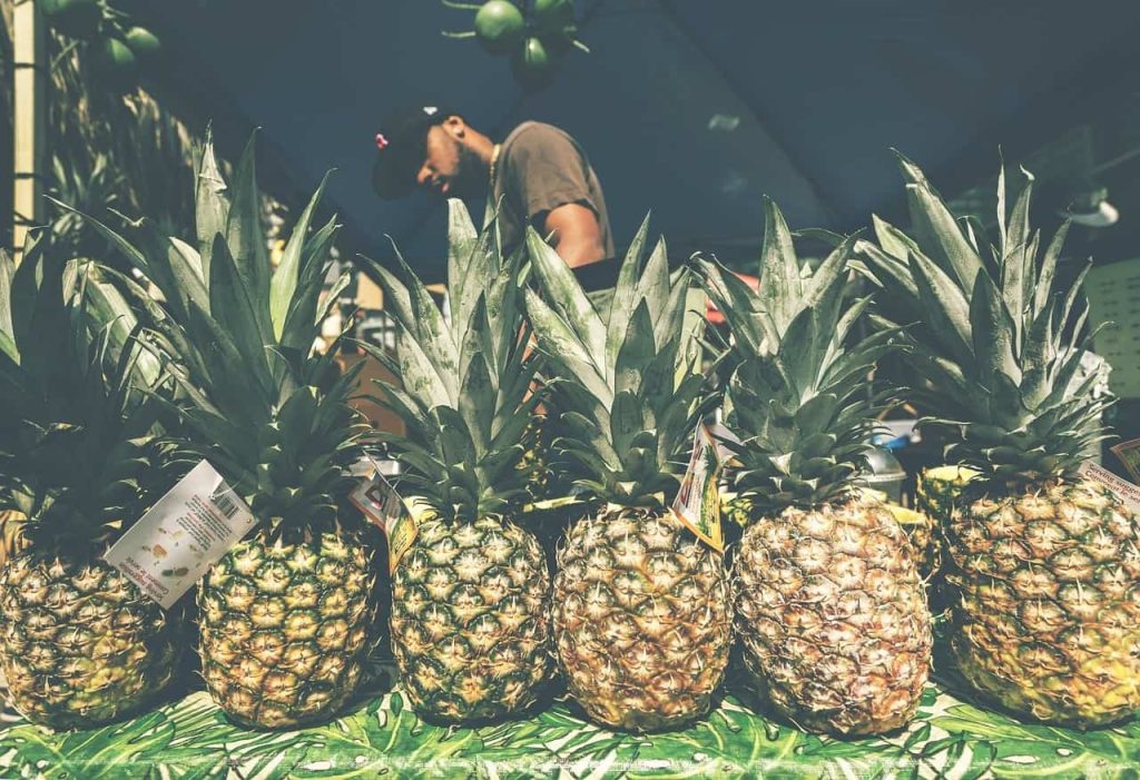 man selling pineapple