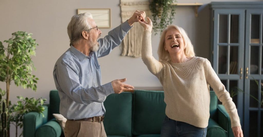 old couple dancing in the living room