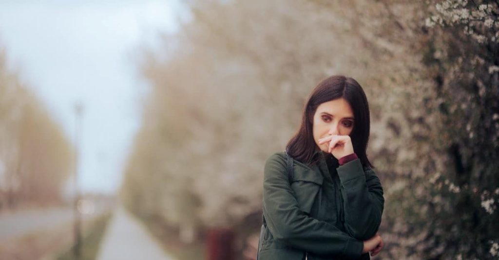 woman touching her nose