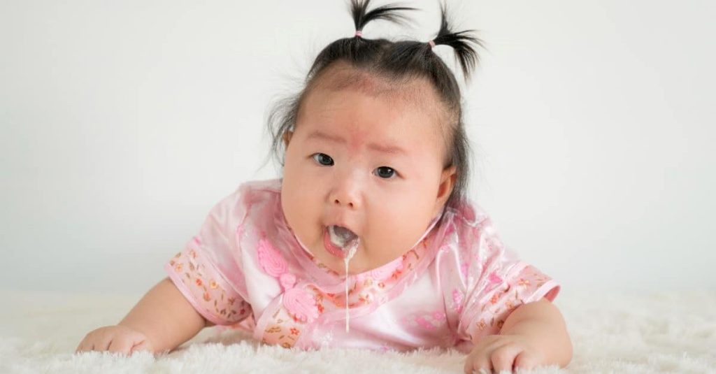 baby girl puking milk
