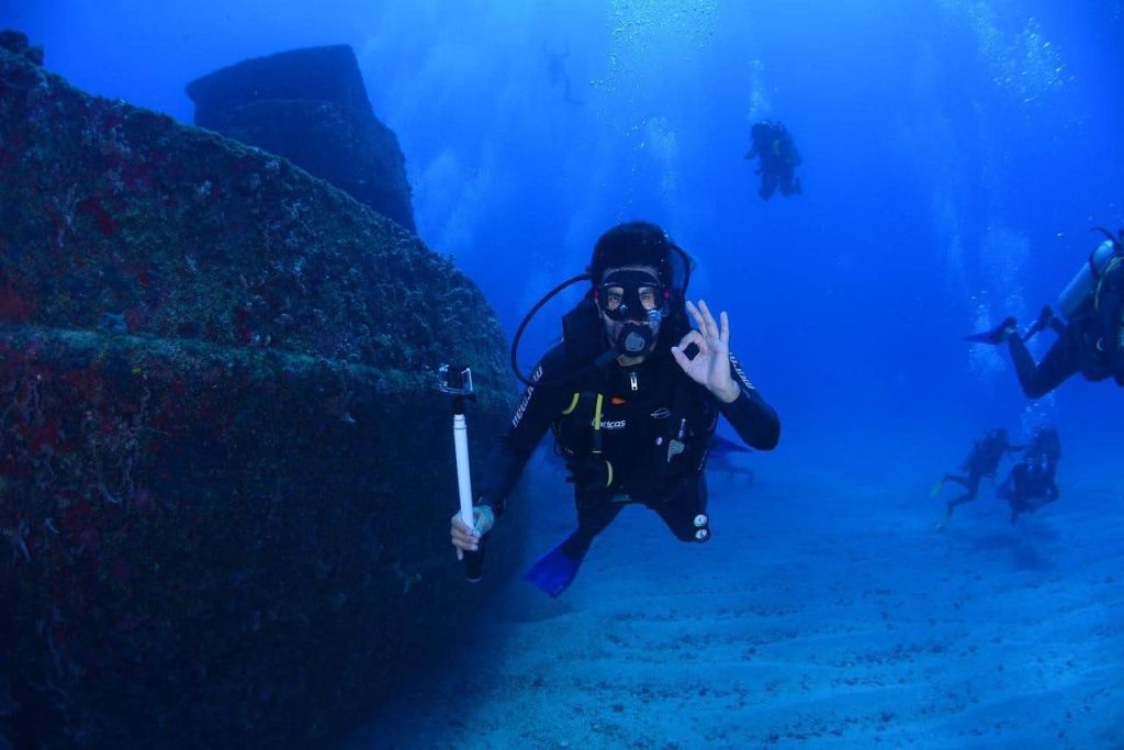 man scuba diving showing okay sign