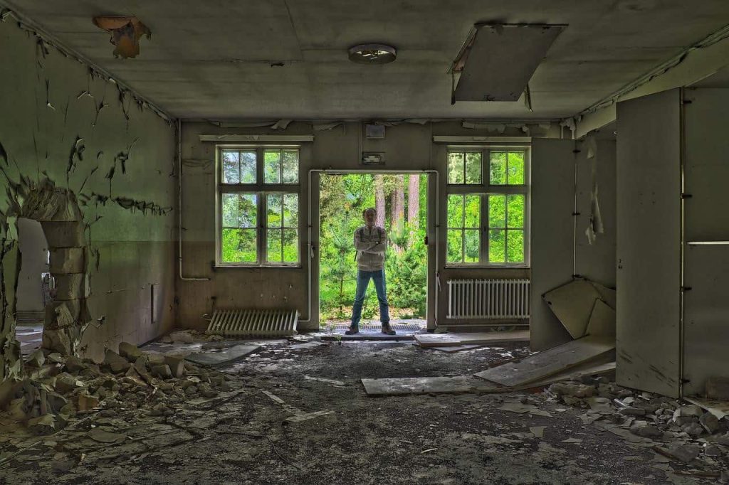 man standing in a collapsed building