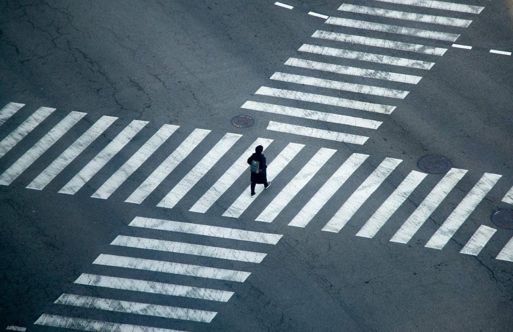 man walking on pedestrian lane