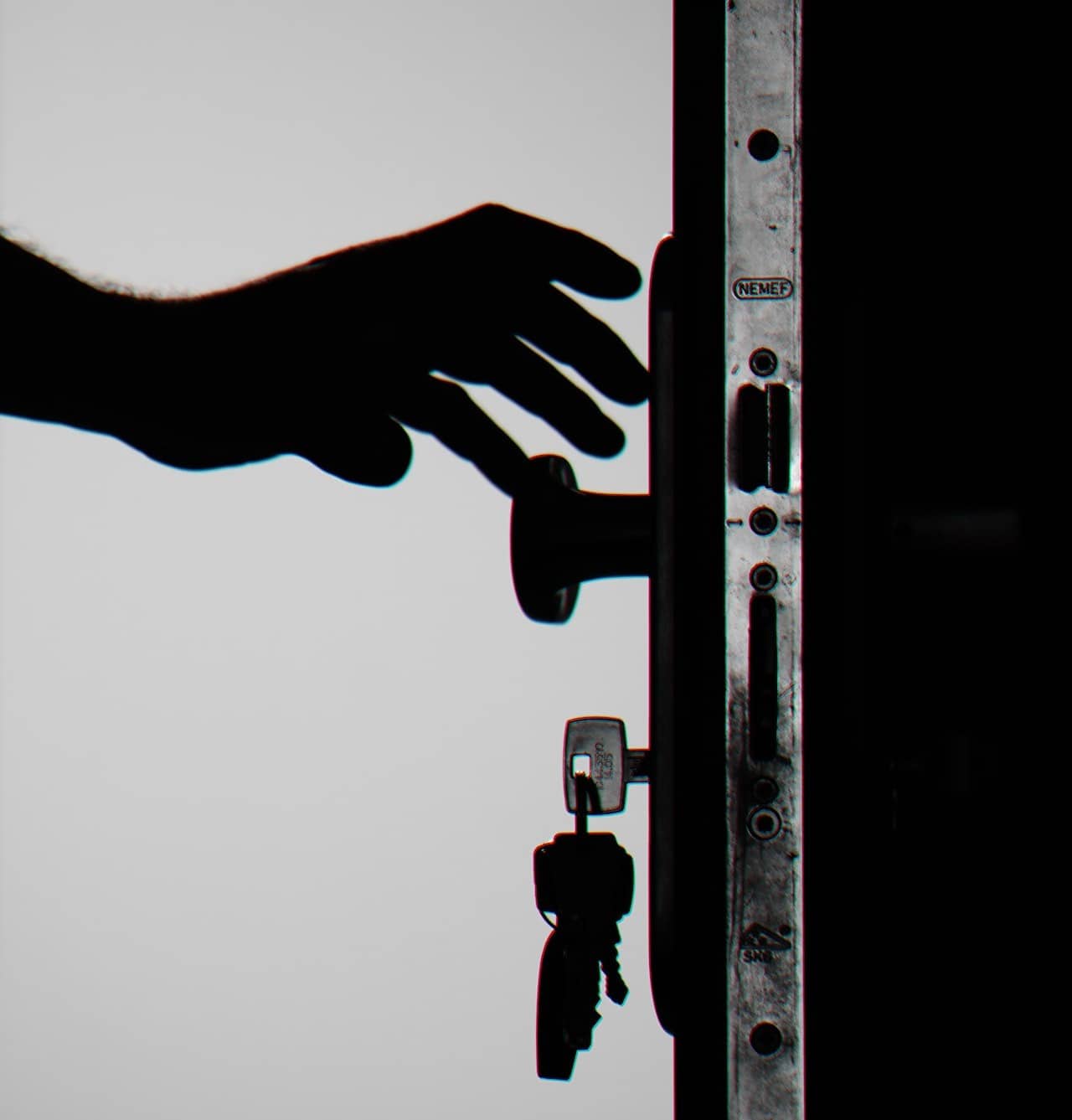 silhoutte of a person opening a door