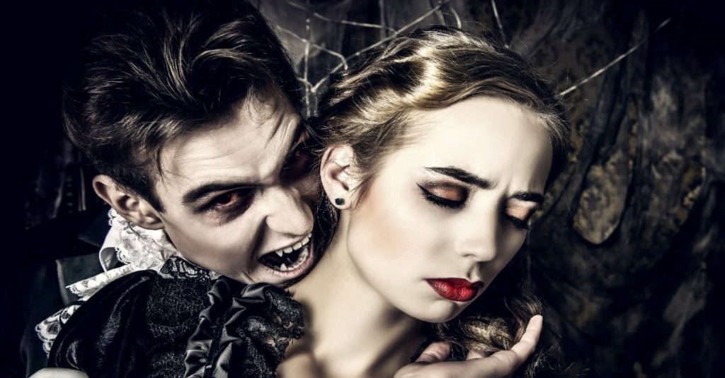 vampire about to bite a woman's neck
