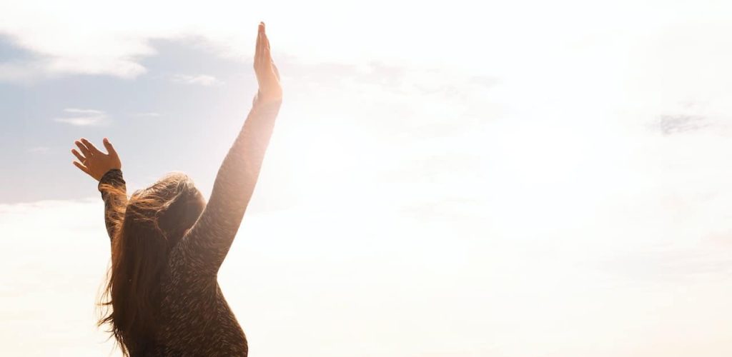 woman open arms basking in the sun