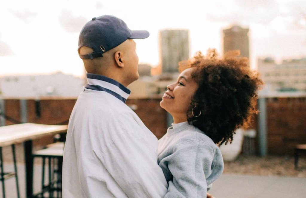 couple wearing jacket hugging each other