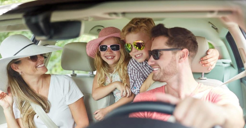 family wearing sunglasses in a car