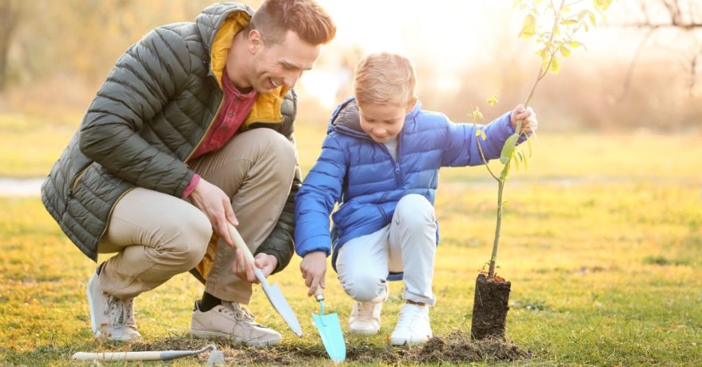 father and son planting a tree