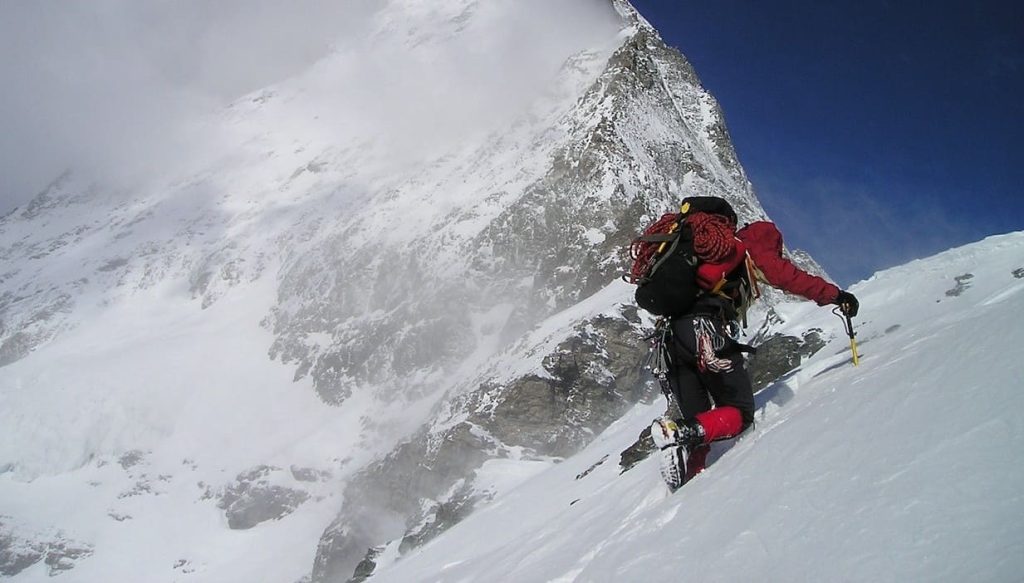 man climbling a glacier mountain