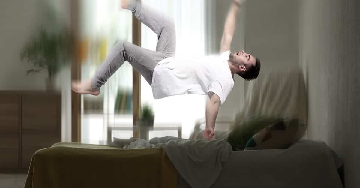man falling down his bed