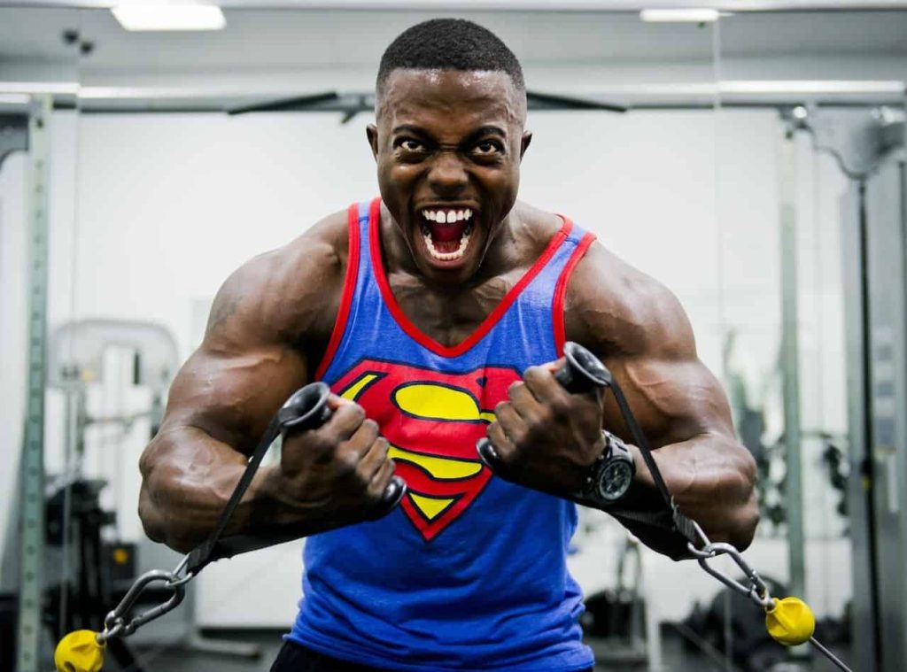man wearing superman tank top building muscle
