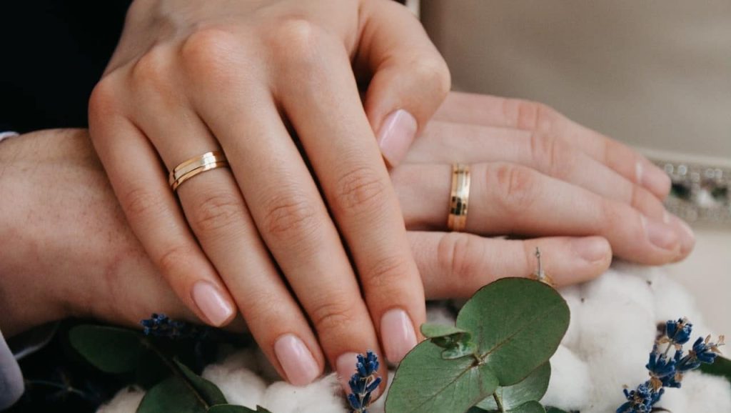 newlyweds hands wearing wedding ring