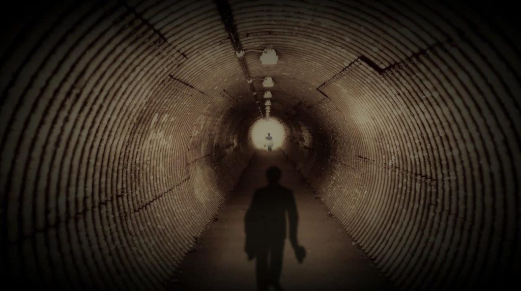 shadow of a person walking on a tunnel