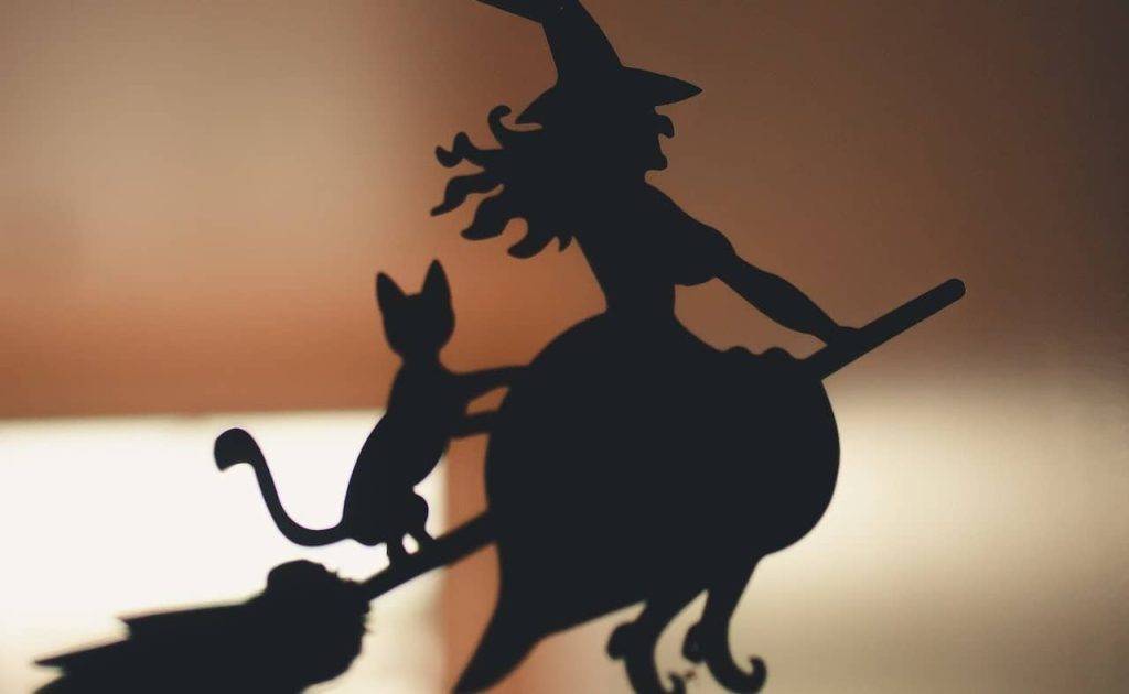 silhoutte of a flying witch on a broomstick