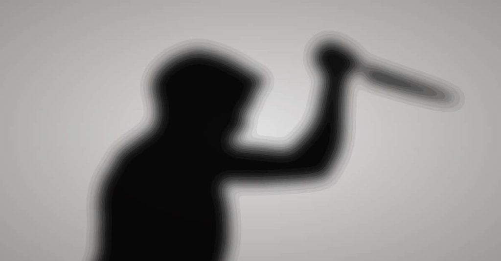 silhoutte of a man holding a knife