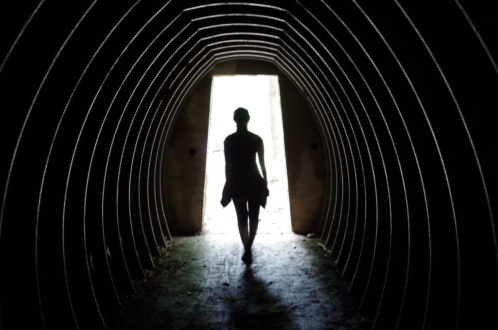 silhoutte of a woman on a tunnel