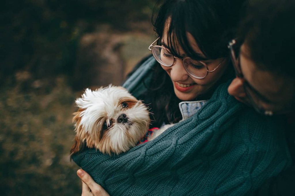 woman carrying puppy