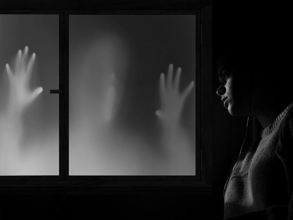 woman indifferent about a shadow in her window