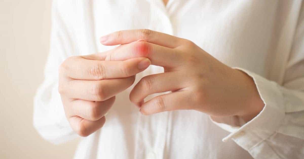woman suffering from finger joint pain