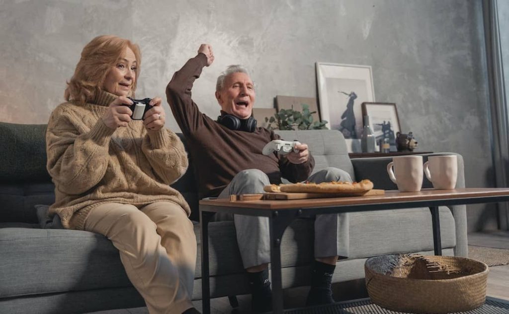 elderly couple playing video game