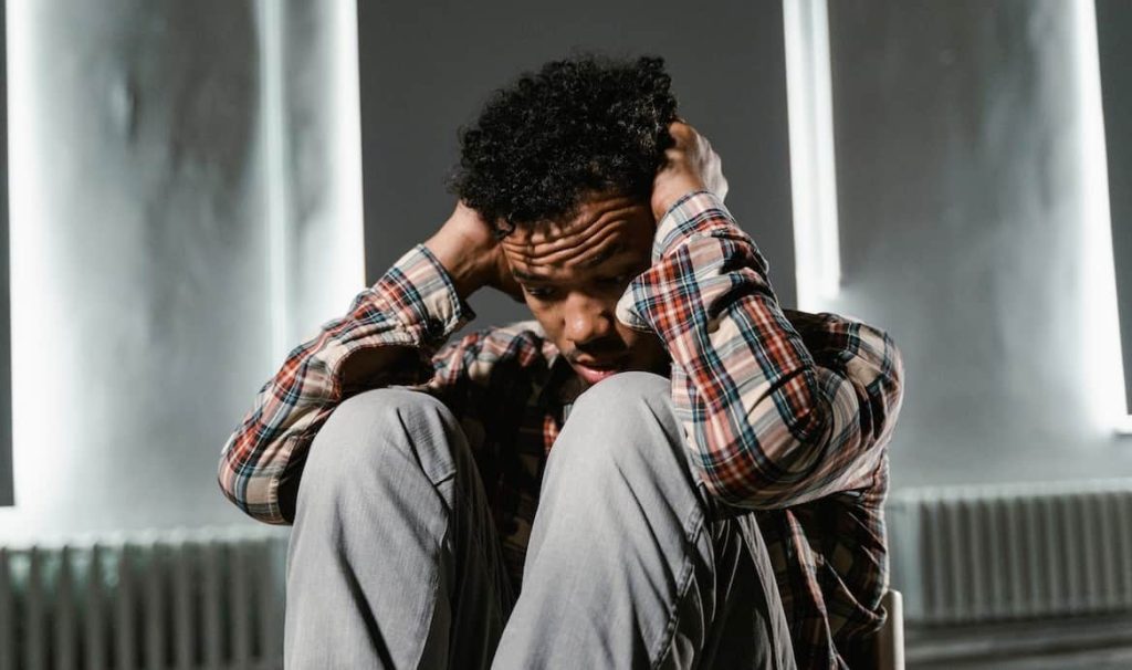 frightened man sitting in a chair