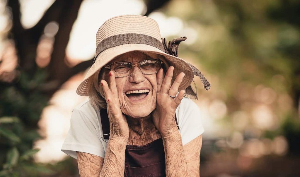 happy old lady wearing brown overall