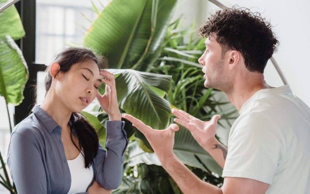 man explaining himself to a frustrated woman