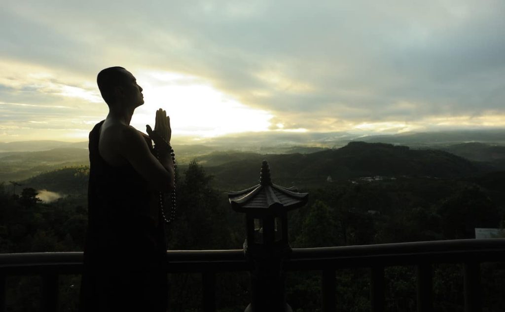 monk holding prayer beads