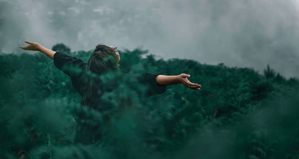 woman standing on a grassfield