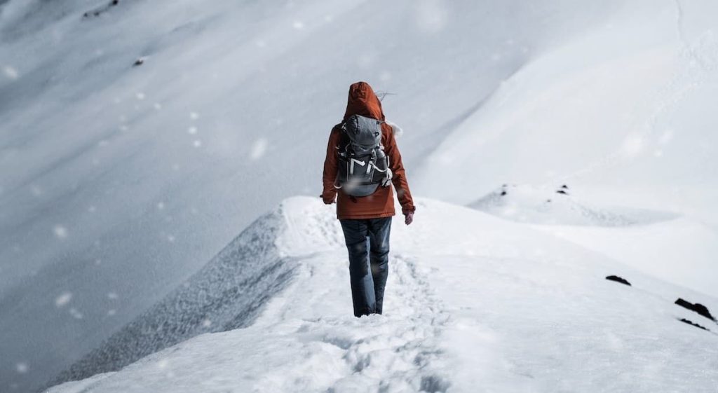 woman walking alone on a snow covered ground