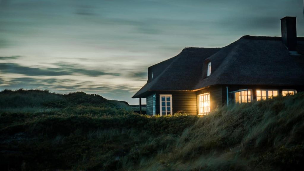 gray house surrounded by grass