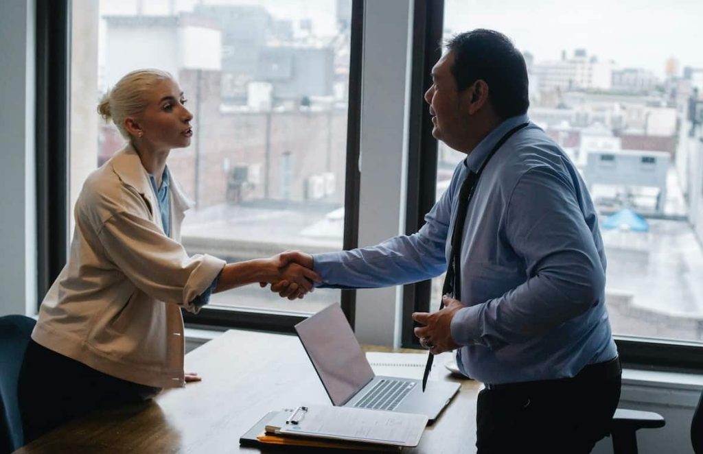 man and woman shaking hands