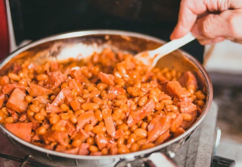 person cooking beans